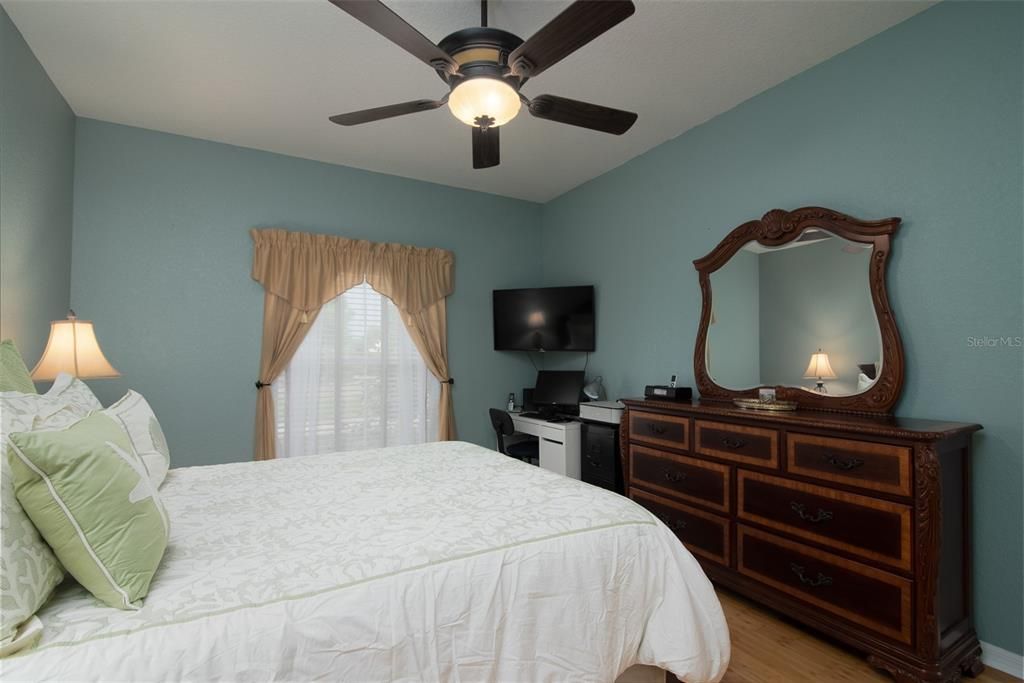 The master bedroom has a custom ceiling fan with light and new bamboo flooring.