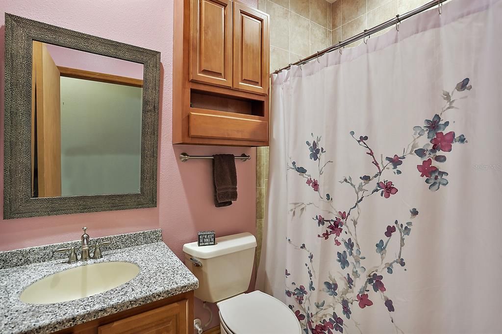 Hall bath with step-in shower. Located just outside the 2nd bedroom.
