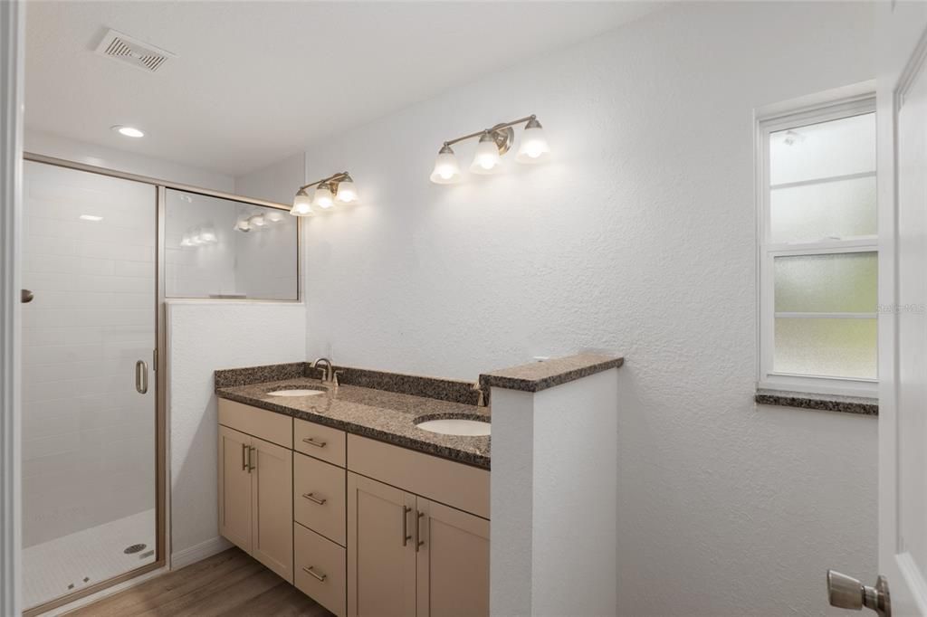 Double vanity (mirror on the way) walk in shower with subway tiles