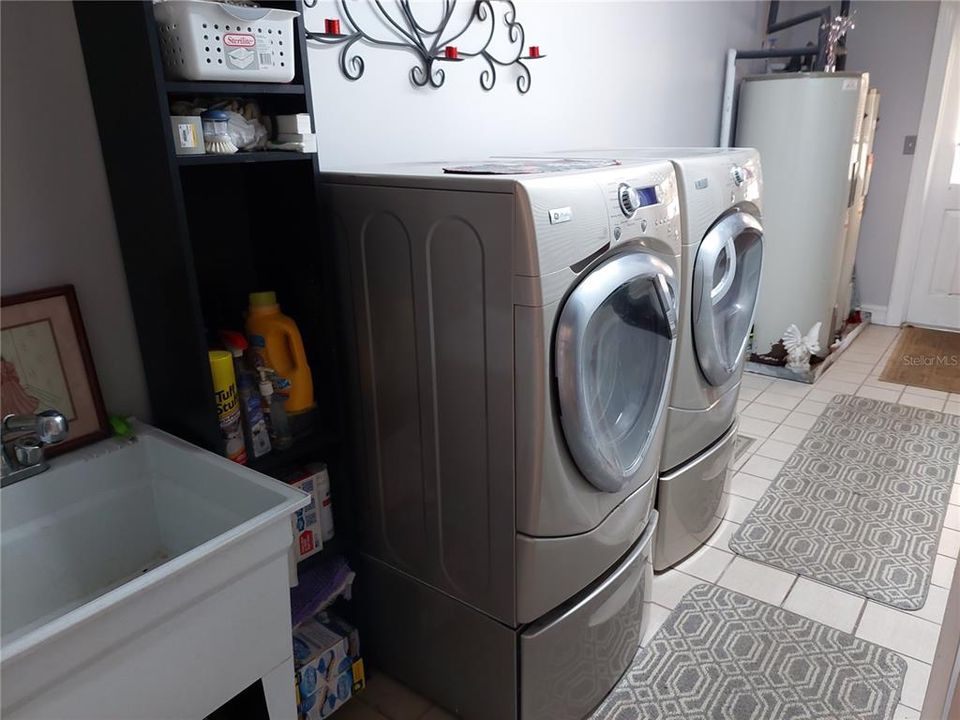 Large Laundry Room with cabinets, Wash sink, and Hot Water Tanks