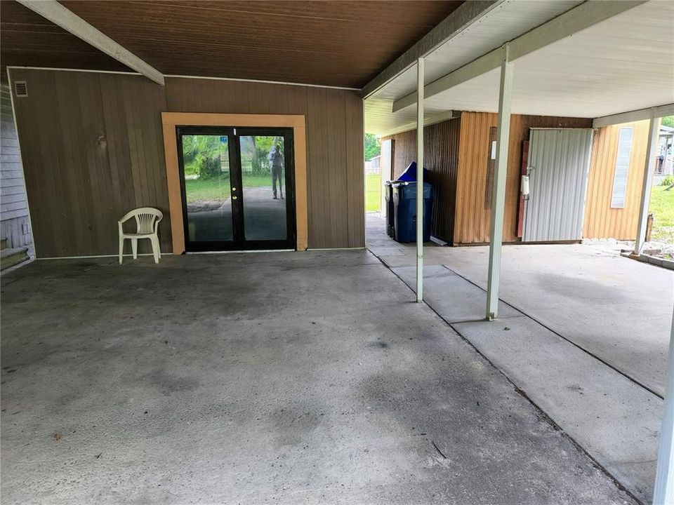 Two sheds with large parking under cover.
