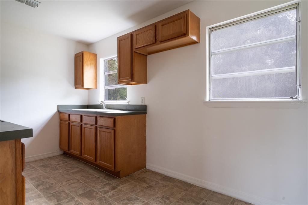 Kitchen. Range and refrigerator are now included and these floors have been replaced with new flooring.