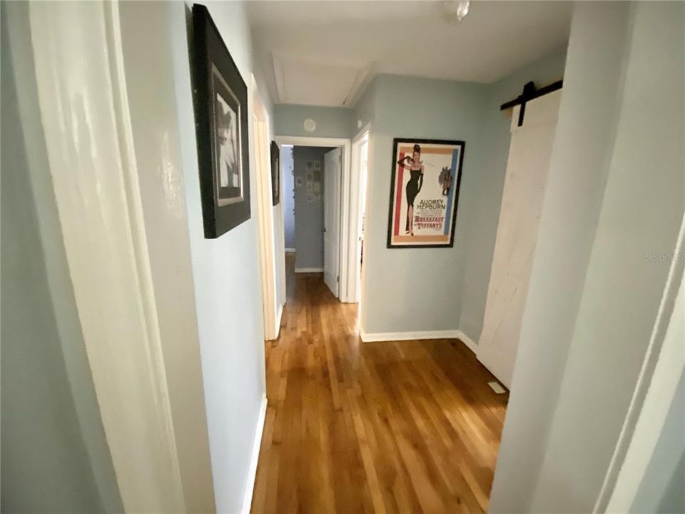 Hallway to 3 bedrooms and full bathroom