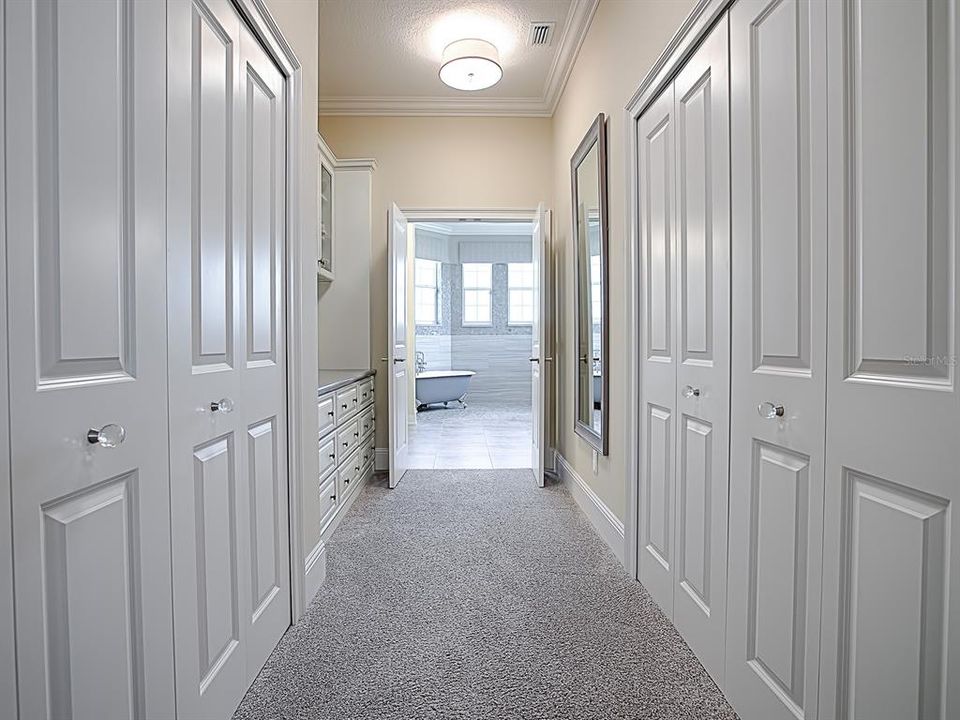 HALLWAY TO MASTER BATH!  LARGE WALK-IN CLOSET ON THE RIGHT WITH BUILT-INS! EXTRA CLOSET AND STORAGE ON THE LEFT!  CUSTOM PACKING COUNTER ON THE LEFT!