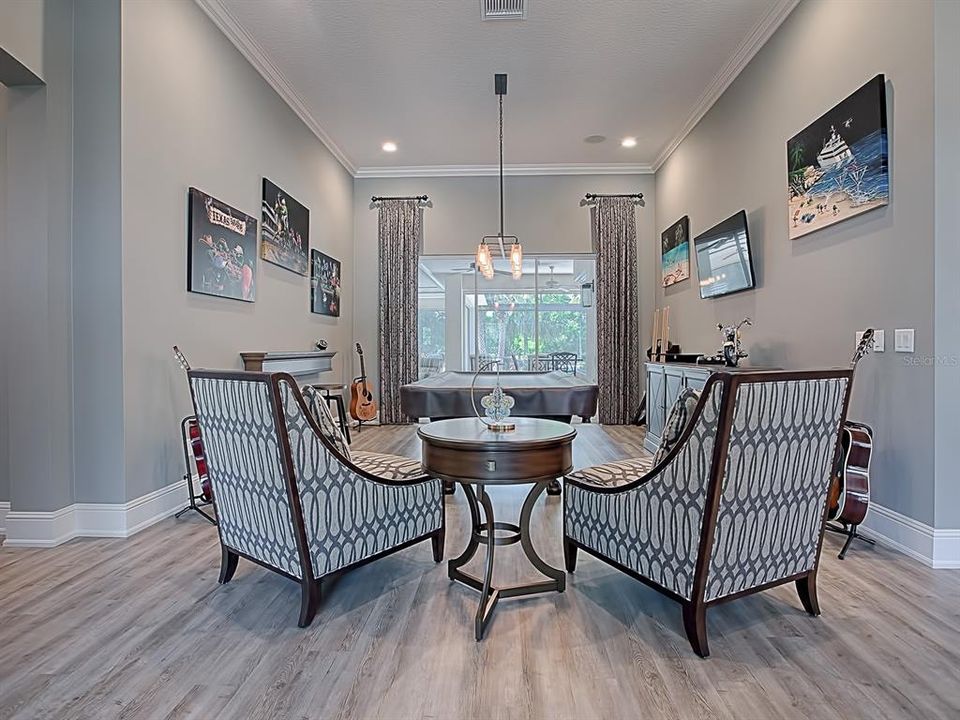 FORMAL LIVING ROOM BEING USED AS A "POOL" ROOM! GREAT VIEW OF THE POOL AND LAKE!