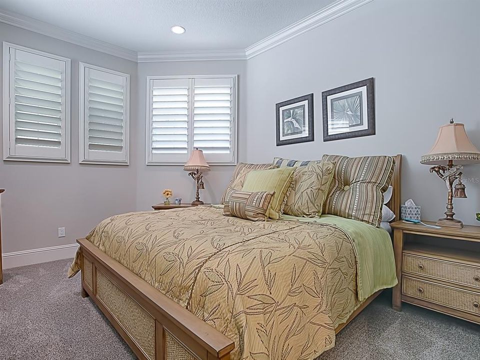 GUEST ROOM WITH PLANTATION SHUTTERS AND CROWN MOLDING!