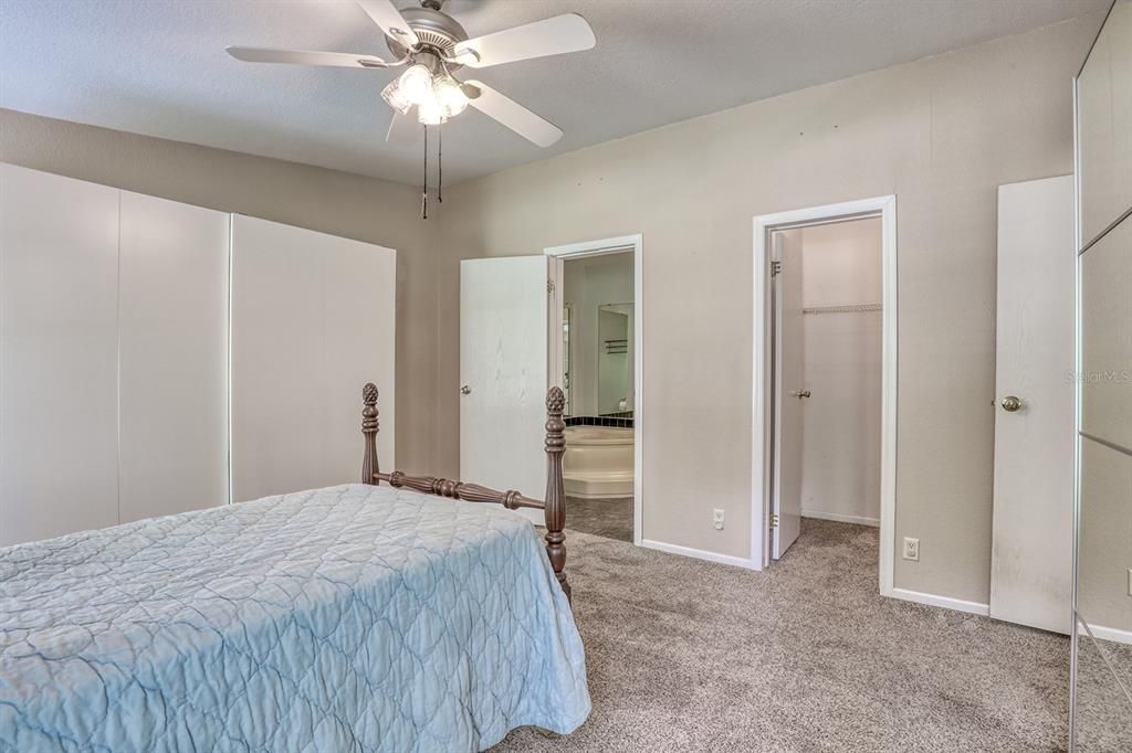 Primary looking at walk in closet and door to bath