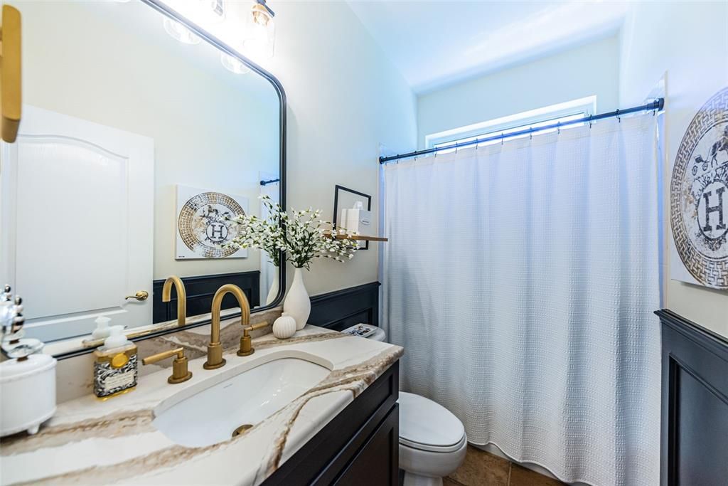 Guest Bath 1 is between bedrooms 2&3...Look at that vanity, granite & wainscot! Stunning!