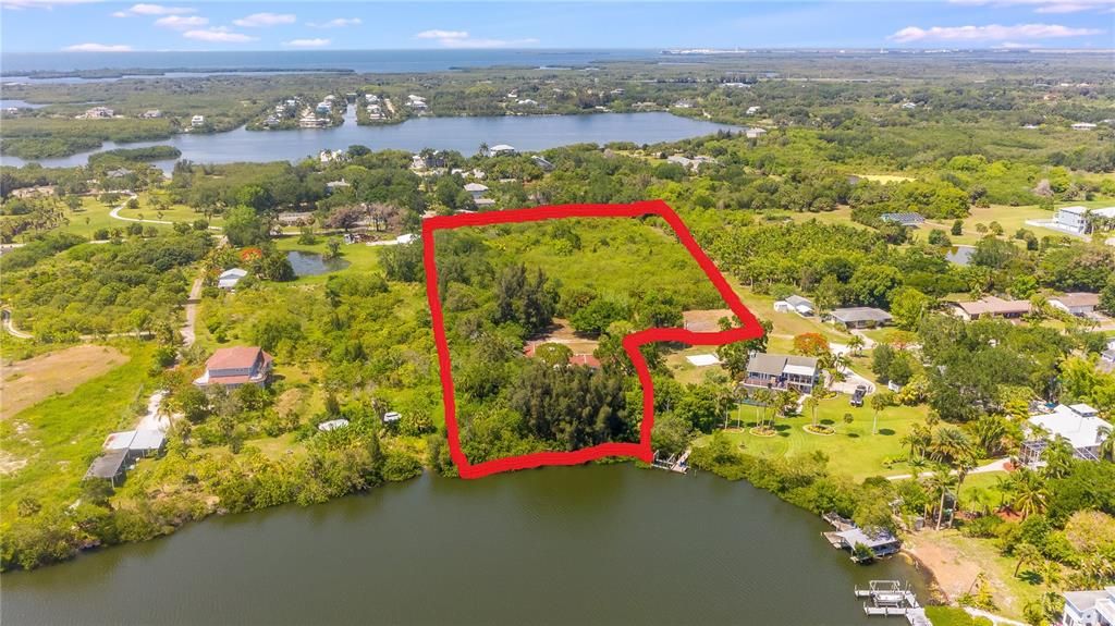 Areal of water, home, and 5.45 acres