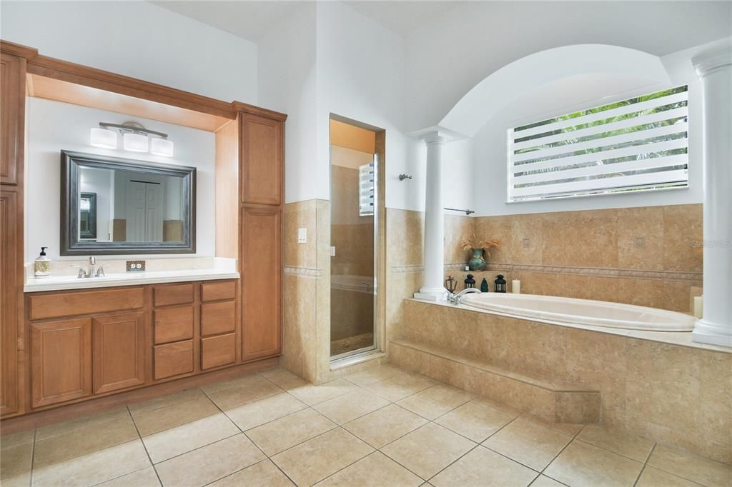 our gorgeous EN-SUITE has everything you need and more - his and her SPLIT VANITIES, a SOAKING TUB complete with columns and a tile surround and a separate shower!