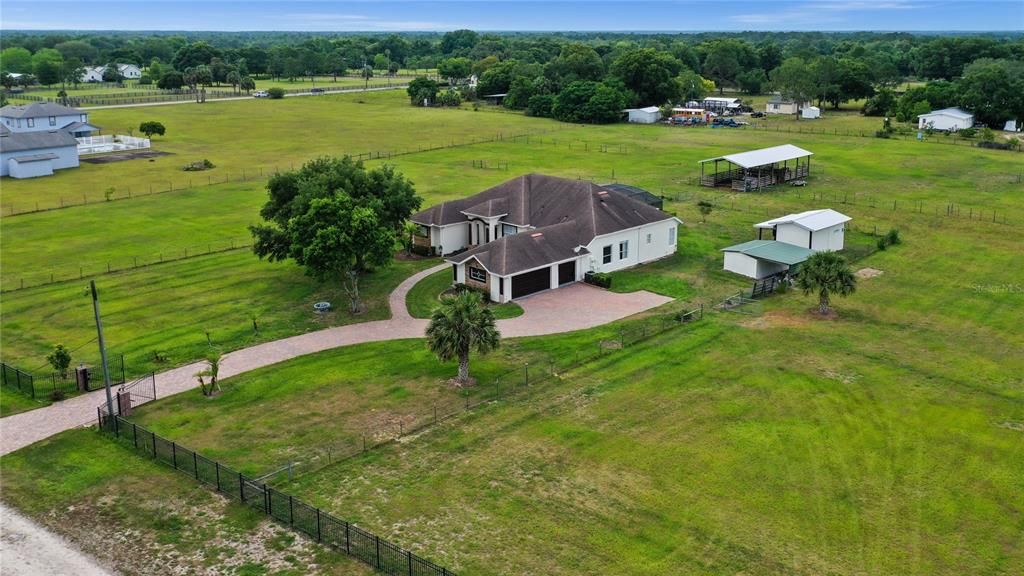 Gorgeous country setting with a small town Geneva feel and a **CUSTOM BUILT POOL HOME** on over **5 ACRES** of high and dry cross FENCED property and ZONED for TOP-RATED SCHOOLS!