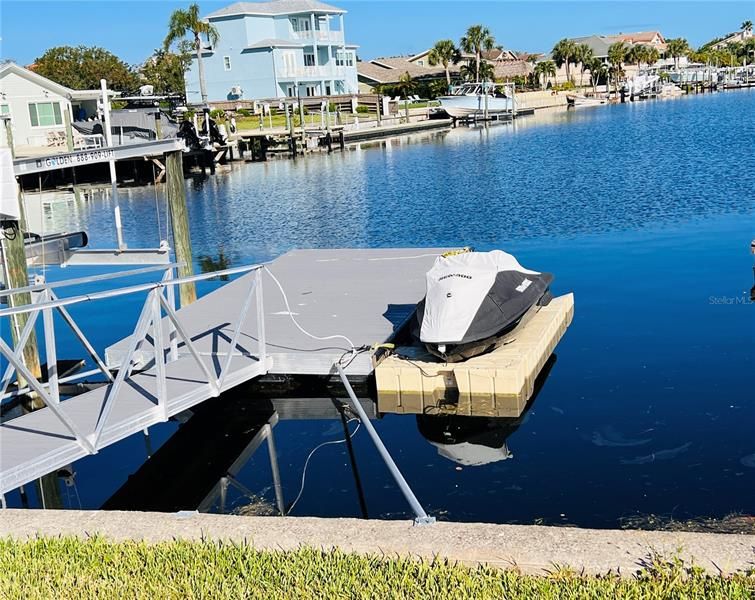 Undamaged by Hurricane Ian. Deeded mooring lot with floating dock & 12k boat lift (in garage waiting for installation) also included, but not the drive on or jet ski. See virtual tour for aerial & interior photos