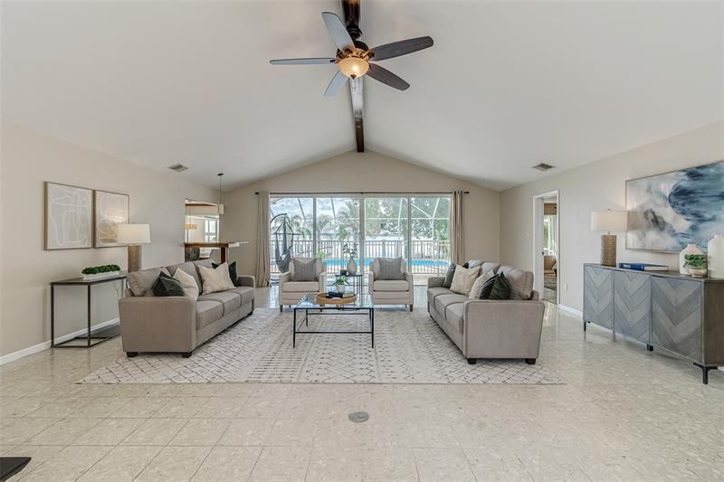 This home is designed to offer tranquil and relaxing lakefront views while enjoying all the modern conveniences.  With multiple sets of sliding glass doors from the living room, dinette, and master bedroom that open to the covered lanai, this home is designed for entertaining and family get-togethers.