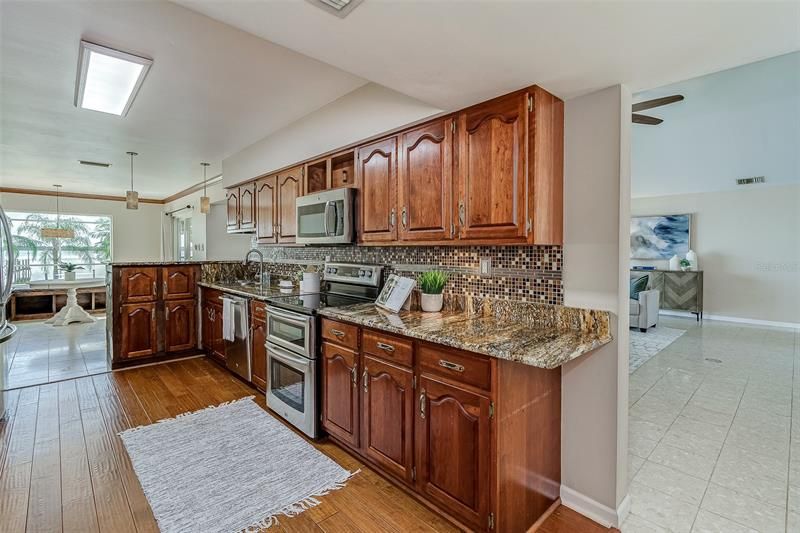 The kitchen is a chef’s delight and boasts beautiful cherry wood cabinets, granite counter tops, stainless steel appliances and a breakfast bar.