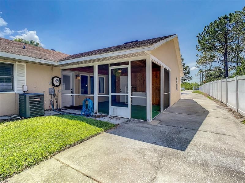 Concrete driveway extends from the front of the property on the left hand side of the home, past the garage.