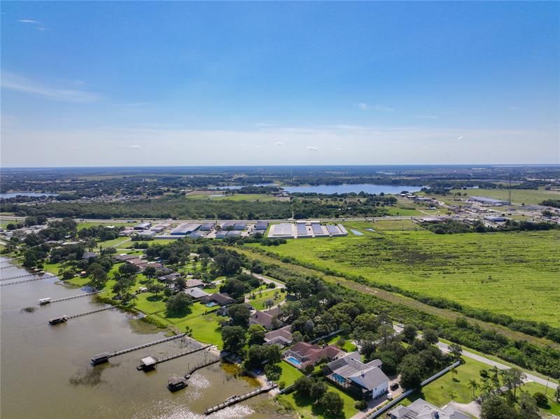 Aerial view of the home and surrounding area and lake front homes.