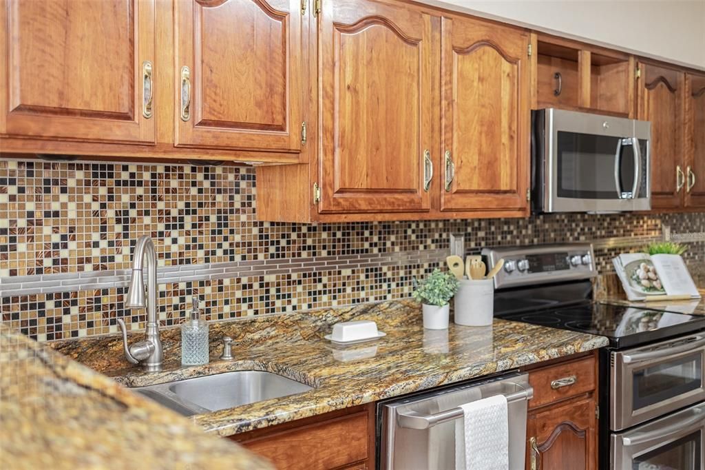 Stainless steel appliances with a double oven electric range.