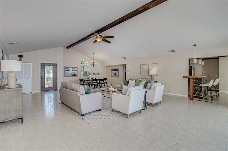 View of the living room/dining room area looking back towards the front entrance door.  The kitchen, breakfast bar  and dinette area are to the right side of the picture.