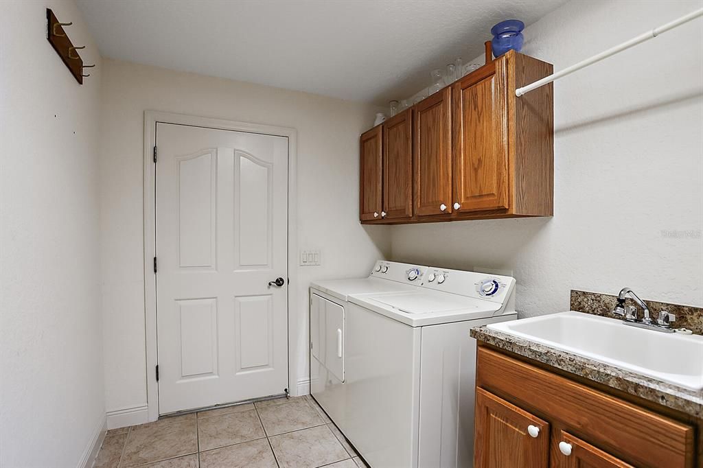 Inside laundry with utility sink & extra cabinets