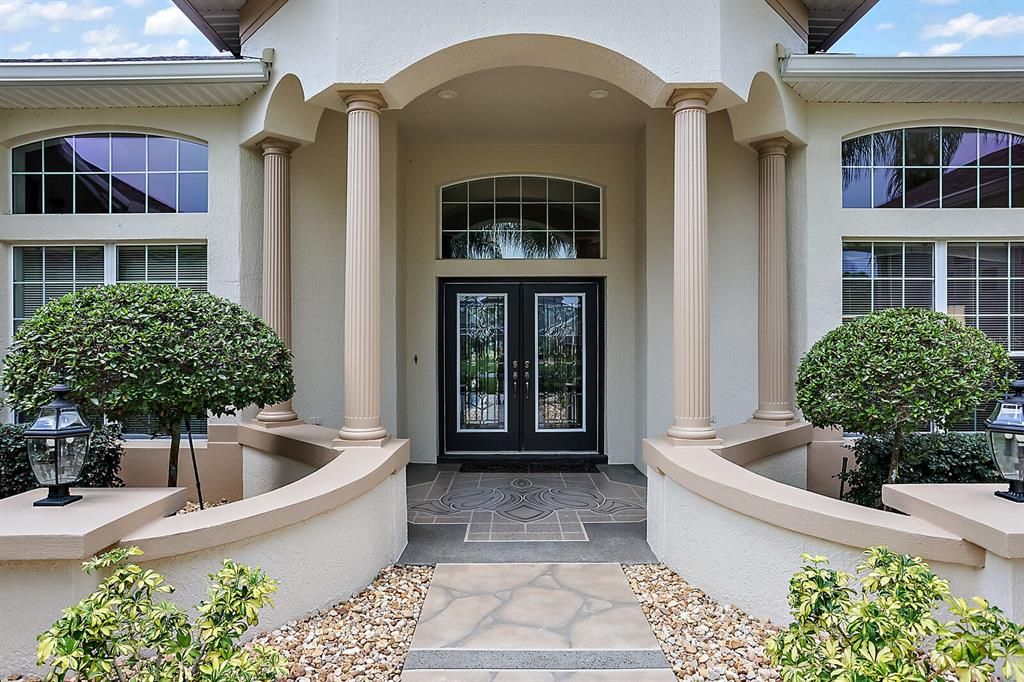 Covered front entrance with elegant double leaded glass doors