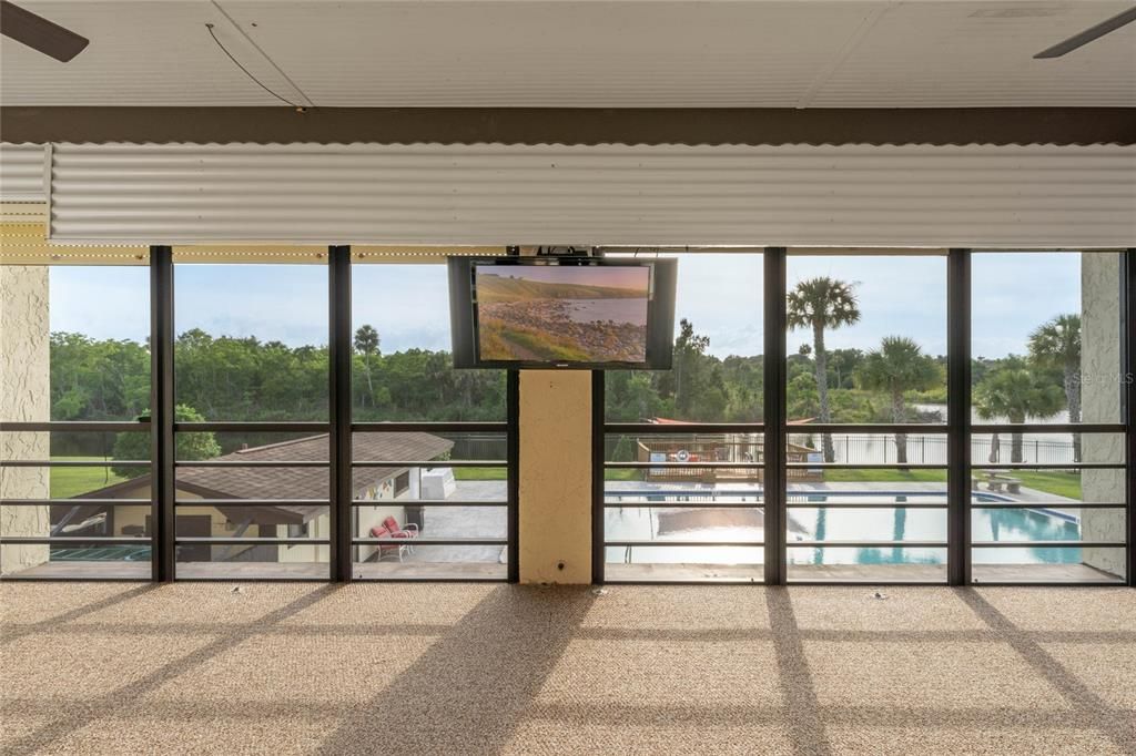 The huge Florida Room adds additional flexible outdoor living space with DIRECT access to the community POOL, and beyond that a stunning WATER and WOODED VIEW!
