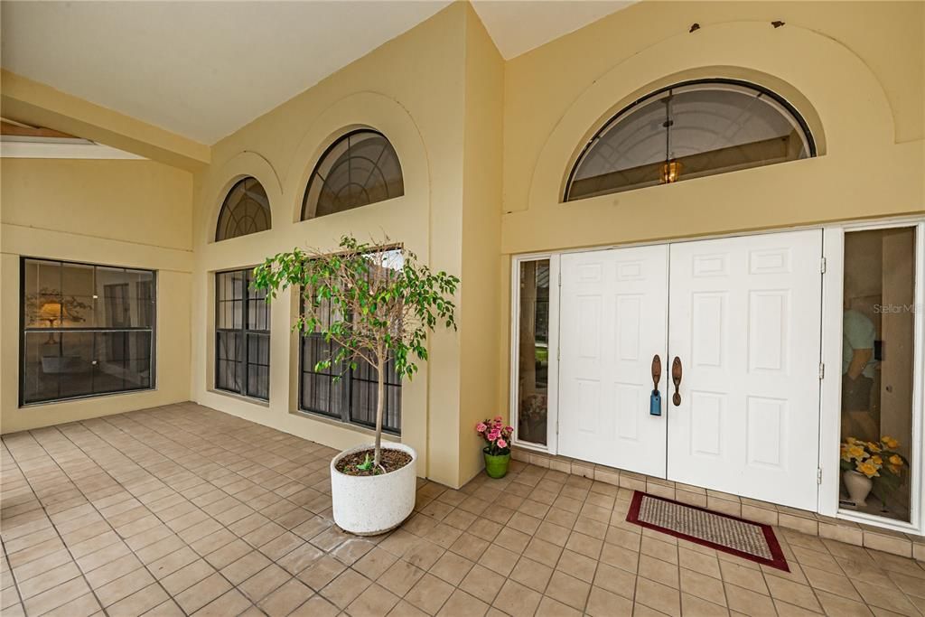 double door entry with large covered porch