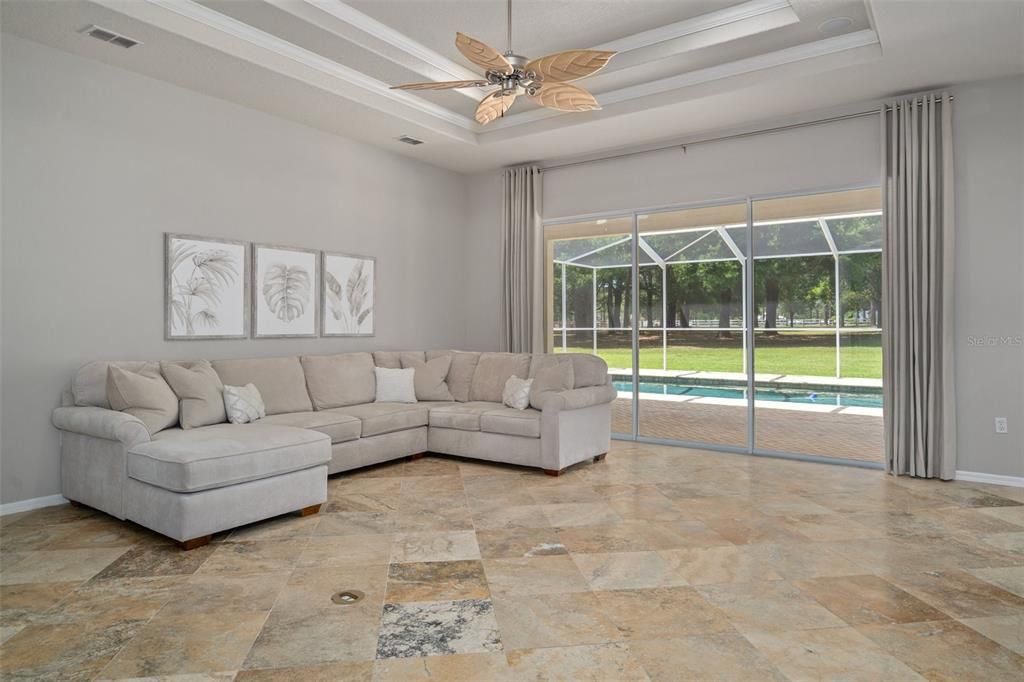 Living Room open to pool. Travertine floors are just beautiful