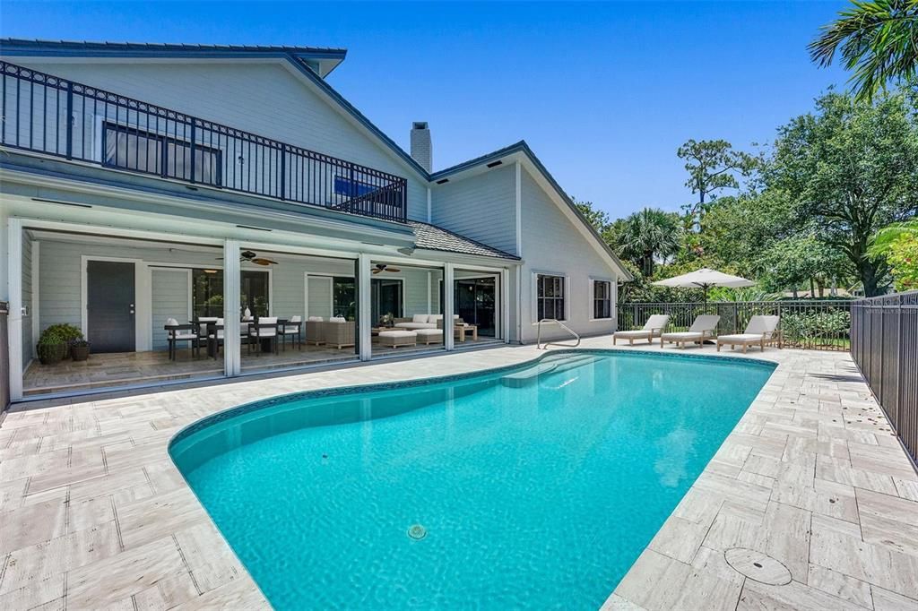 The exterior of this home is just as spectacular - spend the day relaxing under the COVERED LANAI with a motorized retractable screen, splashing in the RESURFACED Quartz Scapes 20,000 gallon SALT WATER POOL, or lounging on the NEWLY REDONE extended pool deck with Travertine Tiles! Virtually Staged.