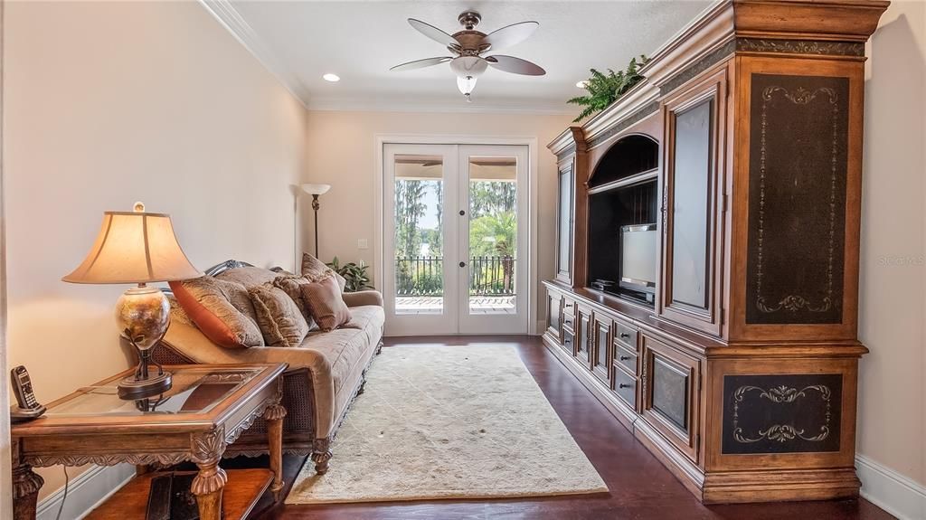 Upstairs bonus living room with doors to balcony