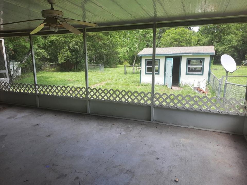 Screened Back Porch with view of workshop & back yard