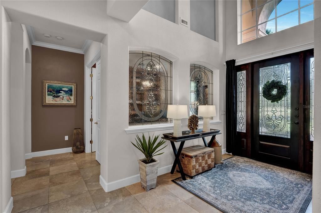 Foyer features gorgeous tiles, coffered ceiling, Juliet balcony
