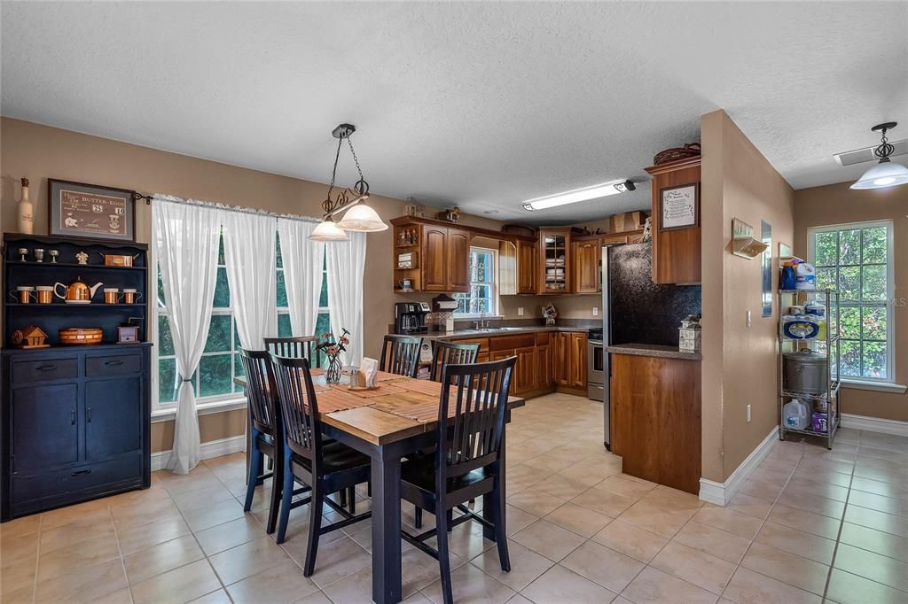 Follow the flow into the open DINING AREA and KITCHEN - another bright space with TILE FLOORS and FRENCH DOORS access to the patio!