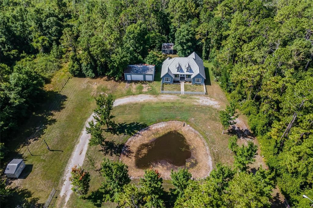 **4.45 ACRES & NO HOA** Tucked away off Sisler Ave, South of SR 50, in the charming Christmas community this 3BD/2BA/3-CAR GARAGE HOME is on almost 5 acres of land surrounded by beautiful mature trees with a METAL ROOF, hardie board siding, shed and so much more!