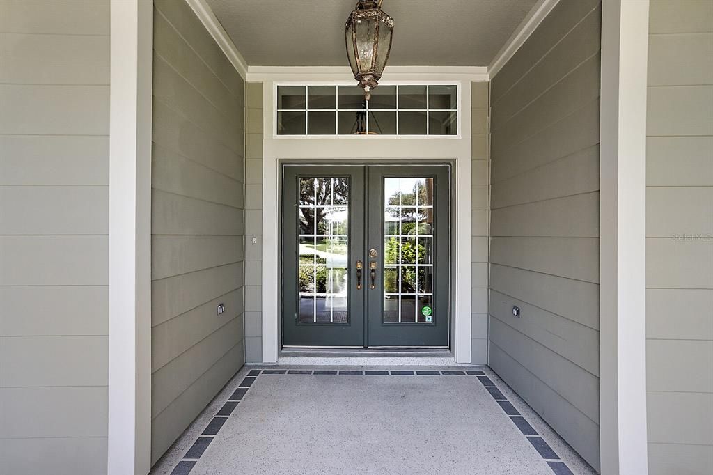 Covered front entrance with elegant double doors