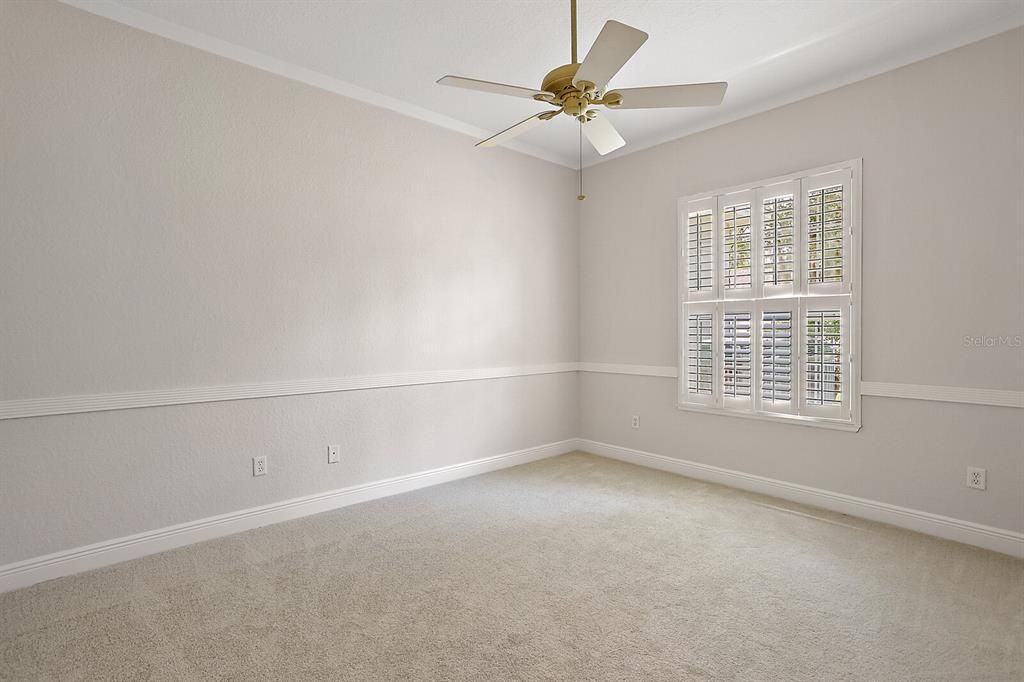 Bedroom 4 with plantation shutters & crown molding