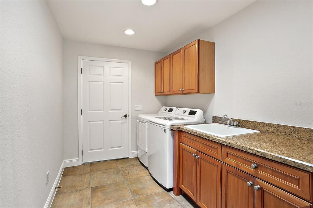 Large inside laundry room with utility sink & extra cabinets