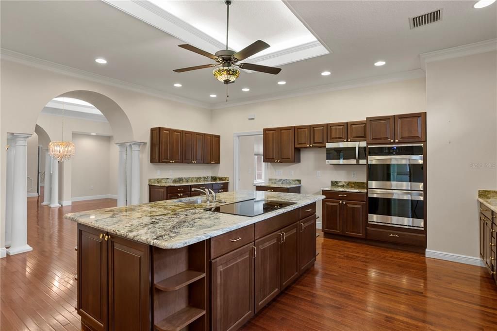 Kitchen looking towards garage hallway with pantry and powder room