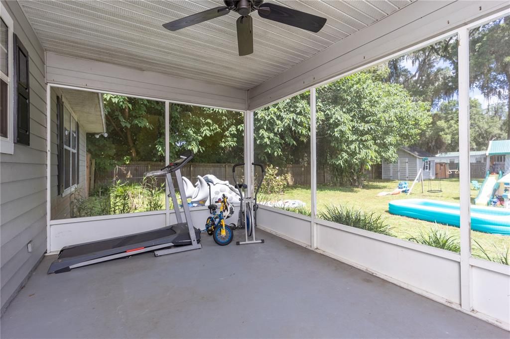Screened back porch overlooking large privacy fenced backyard