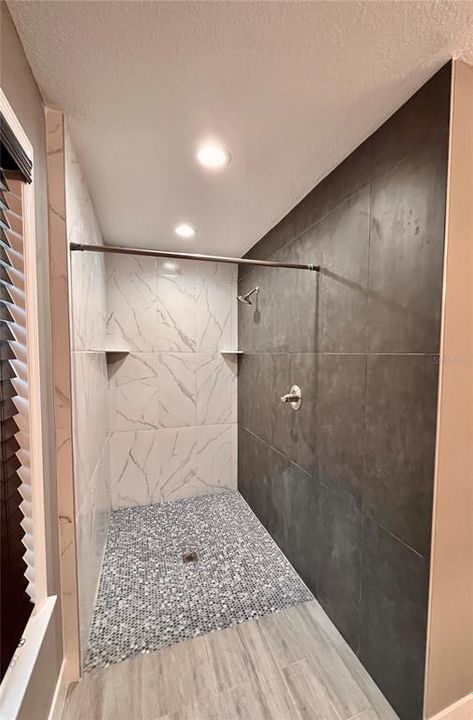 Master large walk in shower with deco tile