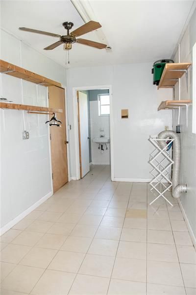 Laundry room leading into bathroom with separate entrance into the garage.