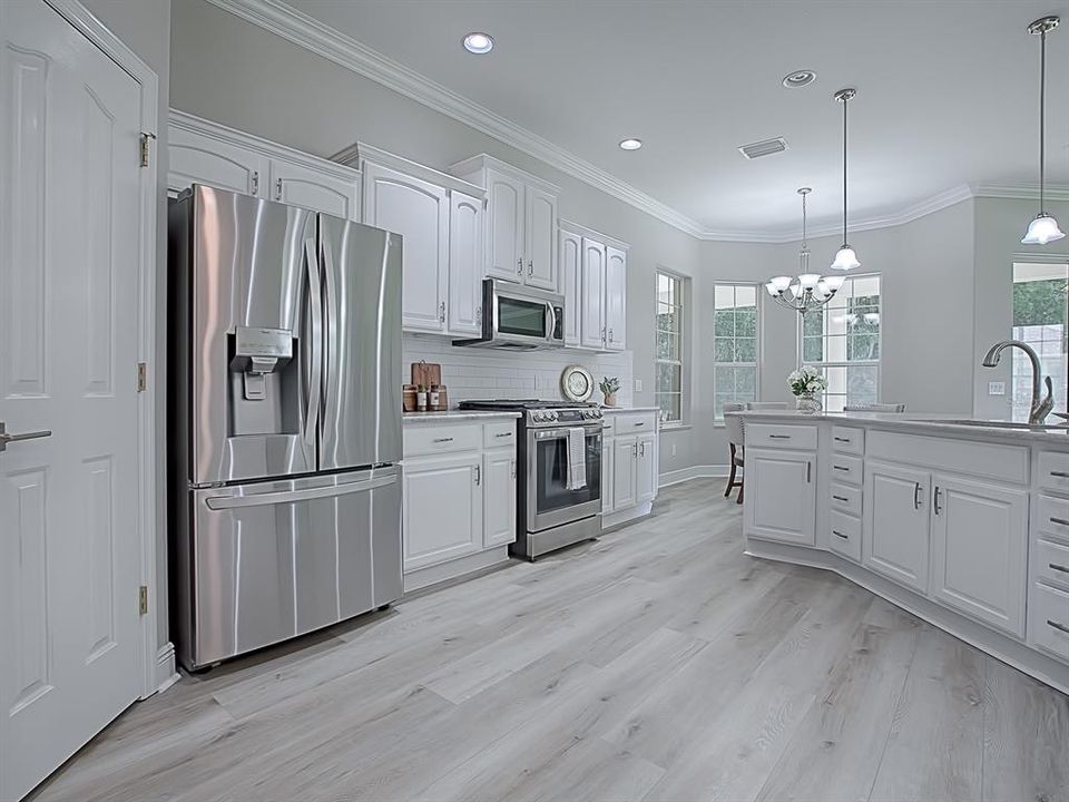 AROUND THE CORNER FROM THE DINING ROOM IS THE ALL NEW KITCHEN!  REFINISHED WHITE CABINETS WITH NEW HARDWARE!