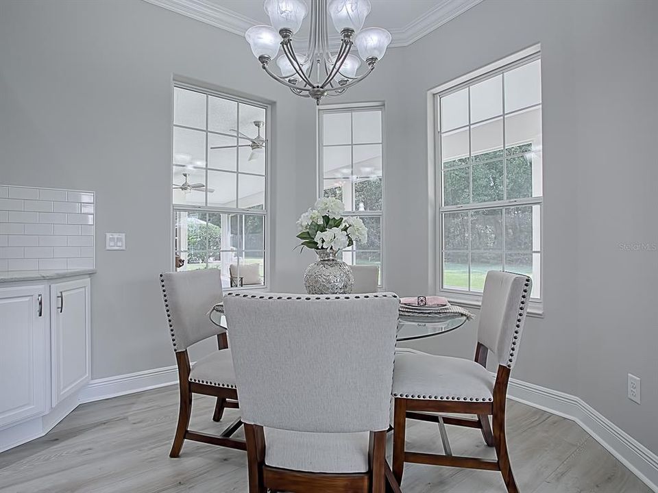 CASUAL DINING AREA OFF THE KITCHEN WITH BAY WINDOW LOOKING OUT OVER THE SPACIOUS BACKYARD AND WOODED VIEW!