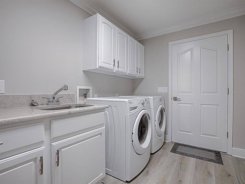 LAUNDRY ROOM LEADS TO THE GARAGE!  NEW REFINISHED CABINETRY, SINK, FAUCET!  FRONT LOAD WASHER AND DRYER DO CONVEY WITH THE HOME!
