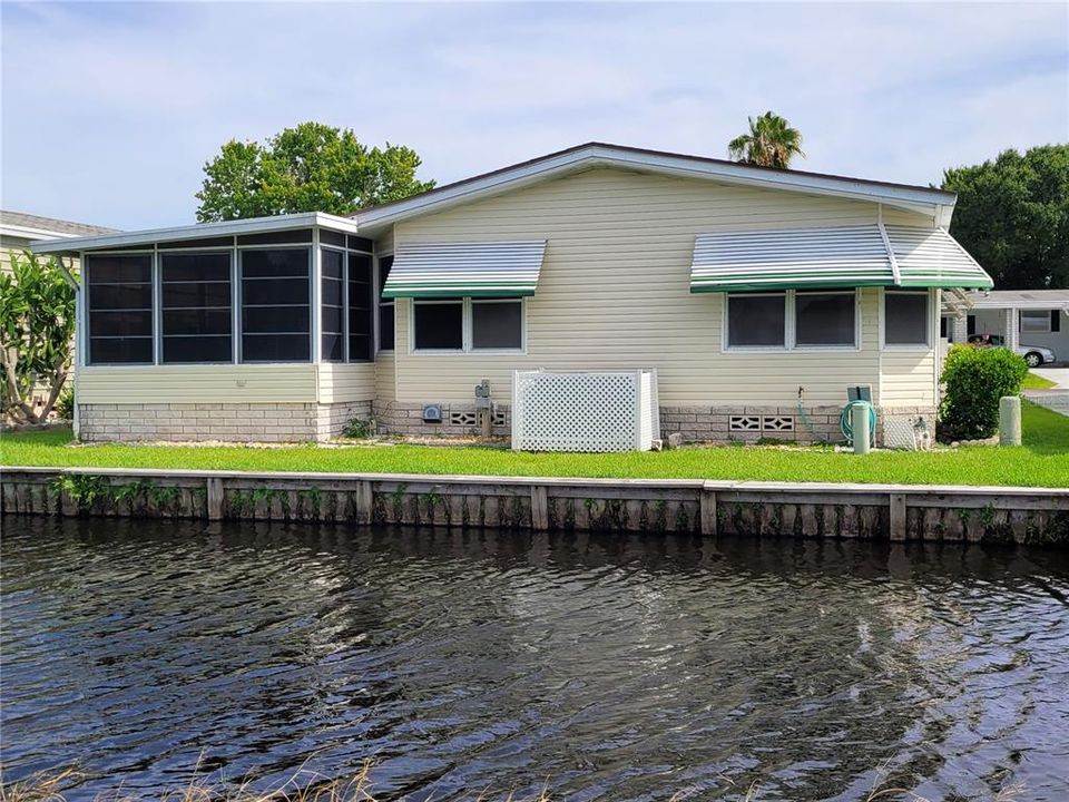 Back of house faces water canal and golf course