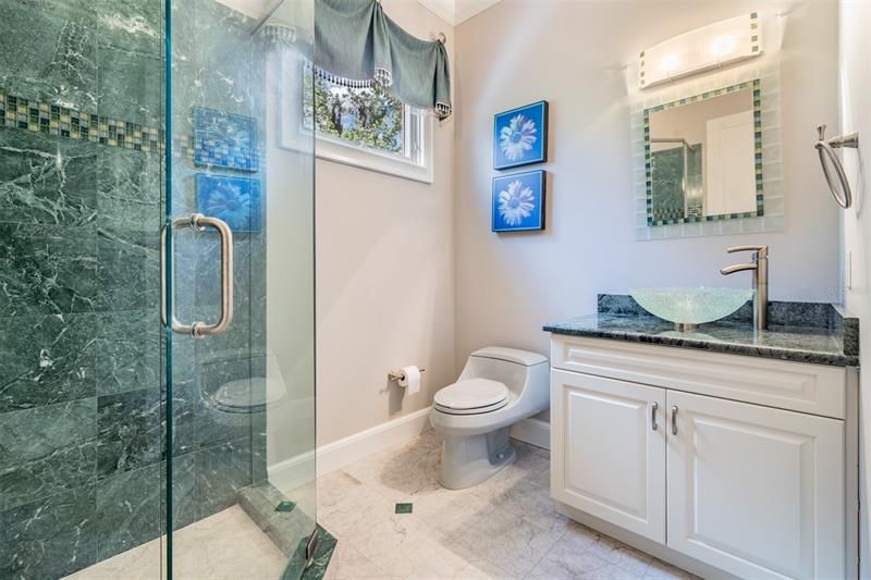 Elegant marble shower and counter in this bath ensuite