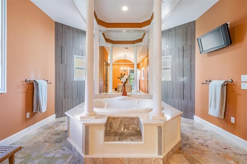 Elegant jetted soaking tub is focal point