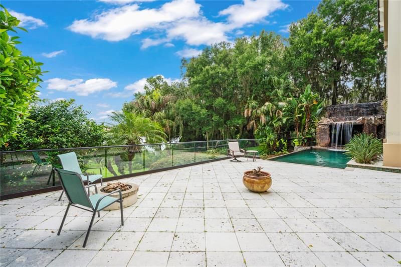 Spacious open patio with firepit overlooks lake