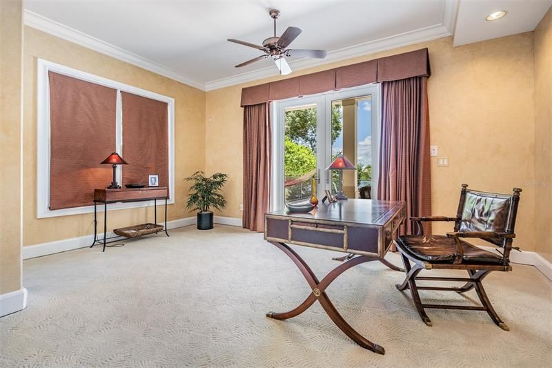 In-law suite bedroom being used as home office with lake views