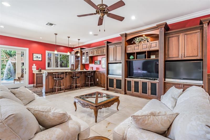 Leisure space with bar and 3 TVs in custom built-ins!