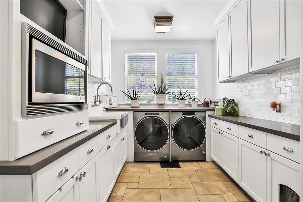 Laundry room with an extra sink and microwave for your convenience.